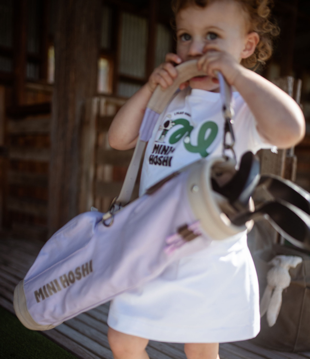 A child carrying the Lilac Purple Mini Hoshi golf bag.